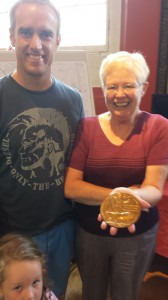 Mother and son, Mr Mark Bosher and Mrs Bosher proudly present the Death Penny given to the family following Thomas Bosher’s death at Mons in 1918